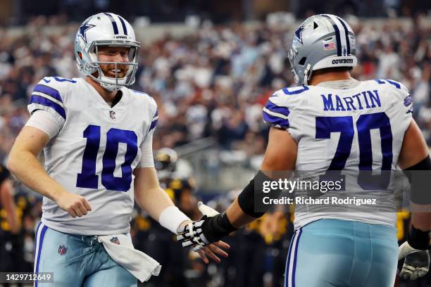 Cooper Rush of the Dallas Cowboys celebrates with Zack Martin of the Dallas Cowboys after a touchdown during the fourth quarter against the...