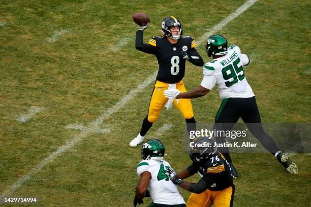 Kenny Pickett of the Pittsburgh Steelers throws a pass while being pressured by Quinnen Williams of the New York Jets in the third quarter at...