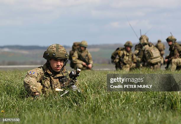 Soldiers from The Royal Regiment of Scotland take cover during the 16 Air Assault Brigade Exercise Joint Warrior at West Freugh Airfield, Stranraer,...