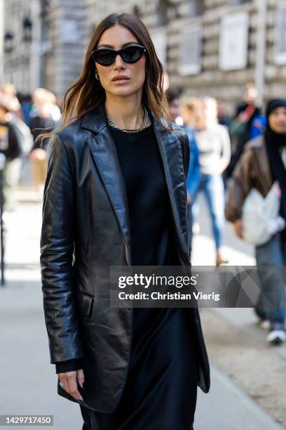 Giorgia Tordini wears black leather blazer, black dress, silver heels outside Loewe during Paris Fashion Week - Womenswear Spring/Summer 2023 : Day...