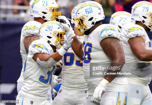 Austin Ekeler and Jamaree Salyer of the Los Angeles Chargers celebrate after Ekeler scored a touchdown in the fourth quarter against the Houston...