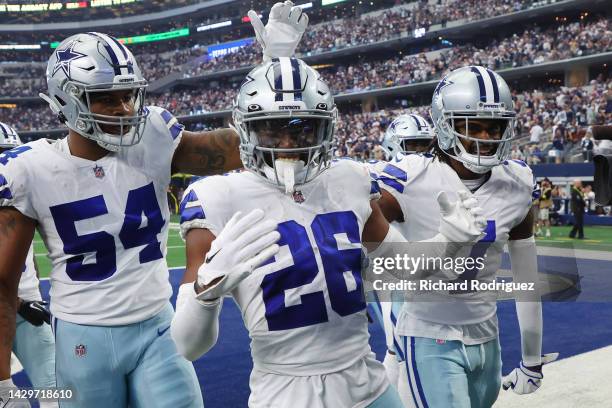 Sam Williams of the Dallas Cowboys and Trevon Diggs of the Dallas Cowboys celebrate with DaRon Bland of the Dallas Cowboys after Bland's interception...