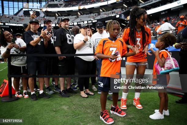 Future Zahir Wilburn, Ciara Wilson, wife of Russell Wilson of the Denver Broncos, and Sienna Princess Wilson look on from the field before the game...