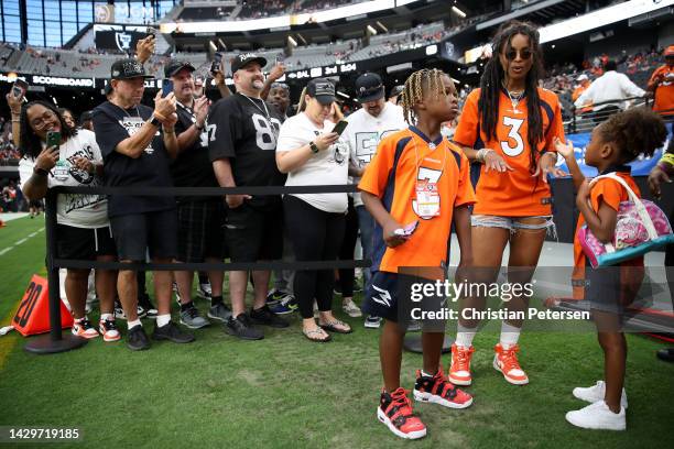 Future Zahir Wilburn, Ciara Wilson, wife of Russell Wilson of the Denver Broncos, and Sienna Princess Wilson look on from the field before the game...