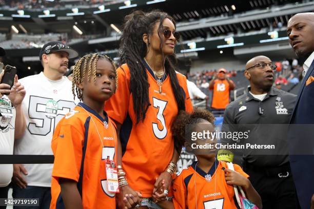 Future Zahir Wilburn, Ciara Wilson, wife of Russell Wilson of the Denver Broncos, and Sienna Princess Wilson look on from the field before the game...
