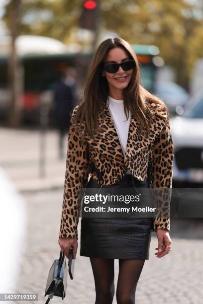 Fashion week guest seen wearing an animal printed jacket and leather skirt, outside Giambattista Valli during Paris Fashion Week on September 30,...