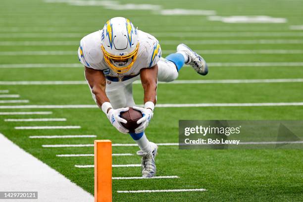 Austin Ekeler of the Los Angeles Chargers dives to score a touchdown in the fourth quarter against the Houston Texans at NRG Stadium on October 02,...