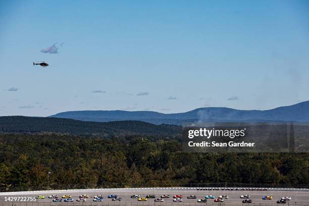 General view of racing as a helicopter flies over during the NASCAR Cup Series YellaWood 500 at Talladega Superspeedway on October 02, 2022 in...