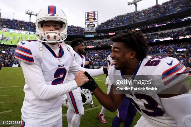 Tyrel Dodson and Tyler Bass of the Buffalo Bills celebrate after Bass kicked a field goal in the fourth quarter to beat the Baltimore Ravens 23-30 at...