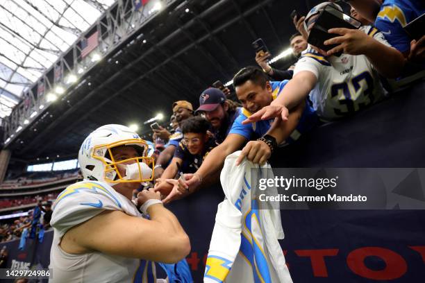 Justin Herbert of the Los Angeles Chargers celebrates with fans after beating the Houston Texans 34-24 at NRG Stadium on October 02, 2022 in Houston,...