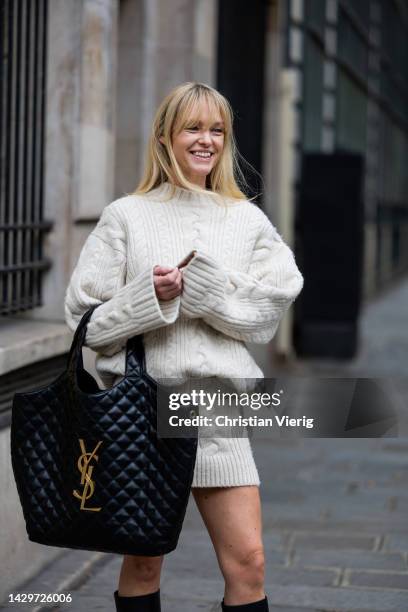 Jeanette Friis Madsen wears black YSL bag, boots, white knitted skirt, jumper outside Ottolinger Paris Fashion Week - Womenswear Spring/Summer 2023 :...