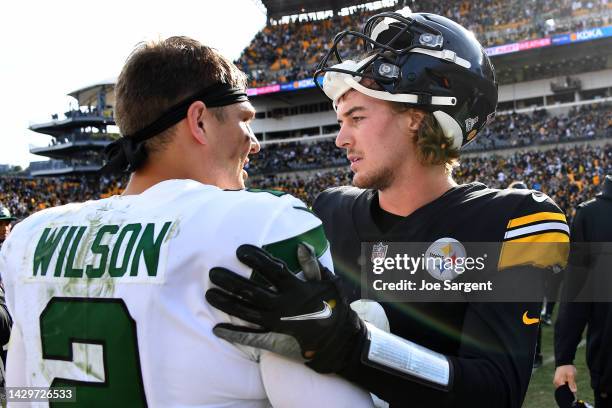 Zach Wilson of the New York Jets and Kenny Pickett of the Pittsburgh Steelers meet after the Jets beat the Steelers 24-20 at Acrisure Stadium on...