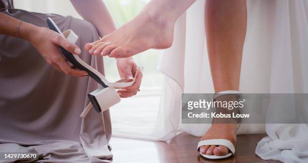 hands of bridesmaid, wedding shoe for bride and help on wedding day or special love event. friends support girl with luxury designer shoes preparing for marriage, partnership or life commitment - evening gowns stock pictures, royalty-free photos & images