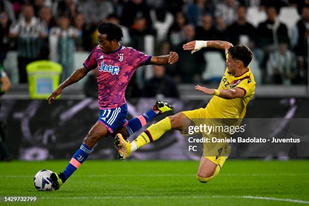 Juan Cuadrado of Juventus is challenged by Joaquin Sosa of Bologna FC during the Serie A match between Juventus and Bologna FC at Allianz Stadium on...