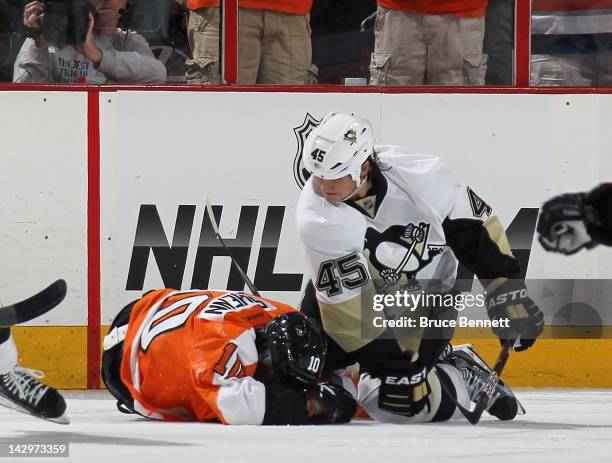 Arron Asham of the Pittsburgh Penguins punches Brayden Schenn of the Philadelphia Flyers in Game Three of the Eastern Conference Quarterfinals during...