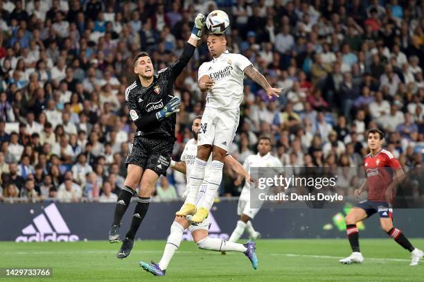 Mariano Diaz of Real Madrid competes for a header with Sergio Herrera of CA Osasuna during the LaLiga Santander match between Real Madrid CF and CA...