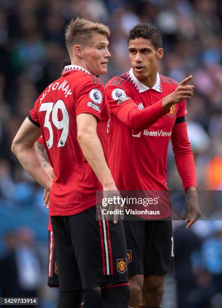 Raphael Varane of Manchester United talks to team mate Scott McTominay during the Premier League match between Manchester City and Manchester United...