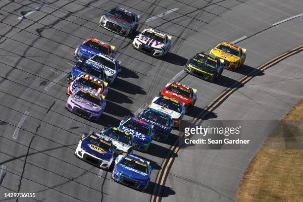 Kyle Larson, driver of the HendrickCars.com Chevrolet, and Chase Elliott, driver of the NAPA Auto Parts Chevrolet, lead the field during the NASCAR...