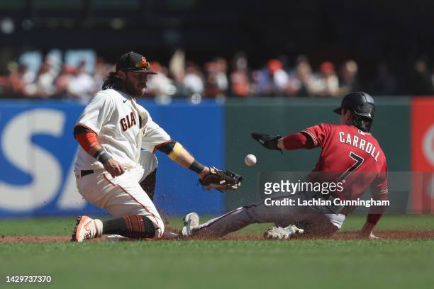 Corbin Carroll of the Arizona Diamondbacks steals second base ahead of Brandon Crawford of the San Francisco Giants in the top of the second inning...
