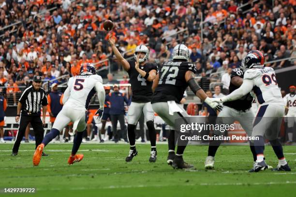 Derek Carr of the Las Vegas Raiders throws a pass while being pressured by Randy Gregory of the Denver Broncos in the second quarter at Allegiant...