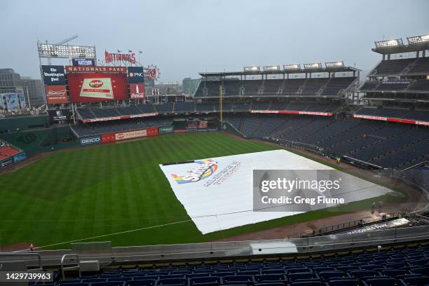 The tarp is on the field during a rain delay at the end of the sixth inning of the game between the Washington Nationals and the Philadelphia...