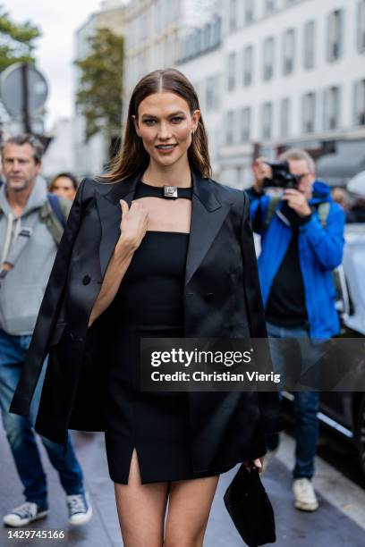 Karlie Kloss wears black cut out dress, blazer, bag outside Givenchy Valentino Paris Fashion Week - Womenswear Spring/Summer 2023 : Day Seven on...