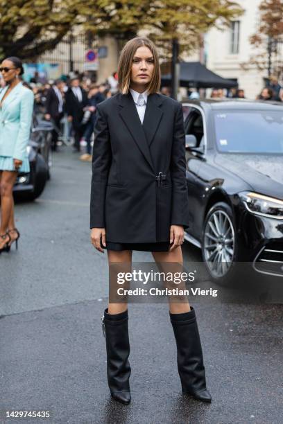 Josephine Skriver wears black blazer, boots, white button shirt outside Givenchy during Paris Fashion Week - Womenswear Spring/Summer 2023 : Day...