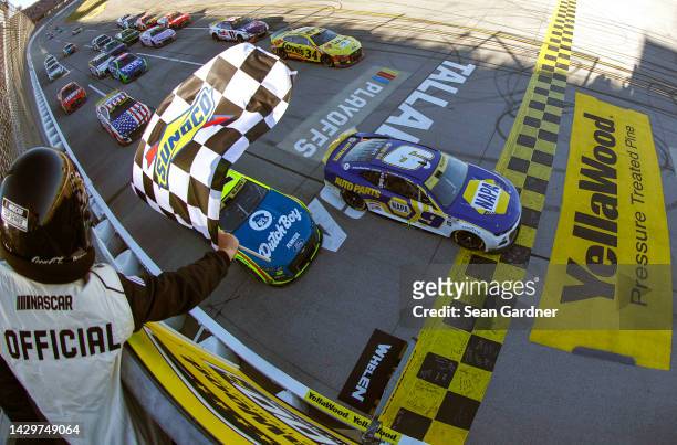 Chase Elliott, driver of the NAPA Auto Parts Chevrolet, takes the checkered flag to win the NASCAR Cup Series YellaWood 500 at Talladega...