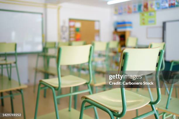 close-up of a chair on a student's desk inside a classroom in a secondary school. - scuola foto e immagini stock