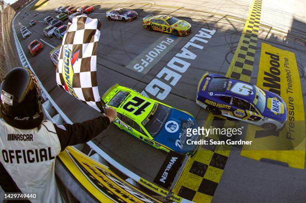 Chase Elliott, driver of the NAPA Auto Parts Chevrolet, takes the checkered flag to win the NASCAR Cup Series YellaWood 500 at Talladega...
