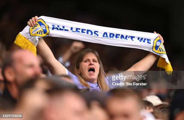 Female Leeds fan sings whilst holding a scarf that reads " All Leeds Aren't we" during the Premier League match between Leeds United and Aston Villa...