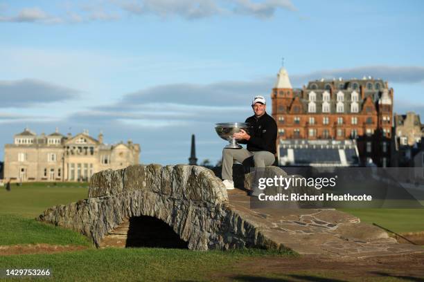 Ryan Fox of New Zealand poses with the trophy on the Swilcan Bridge on the 18th hole after winning the Alfred Dunhill Links Championship at the Old...