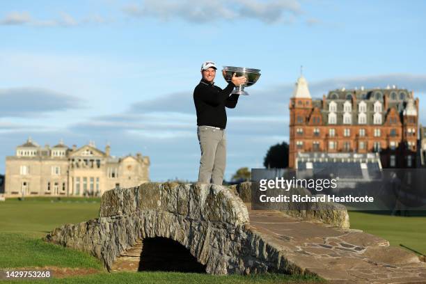 Ryan Fox of New Zealand poses with the trophy on the Swilcan Bridge on the 18th hole after winning the Alfred Dunhill Links Championship at the Old...