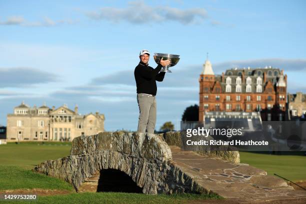 Ryan Fox of New Zealand poses with the trophy on the Swilcan Bridge on the 18th hole after winning the Alfred Dunhill Links Championship at the Old...