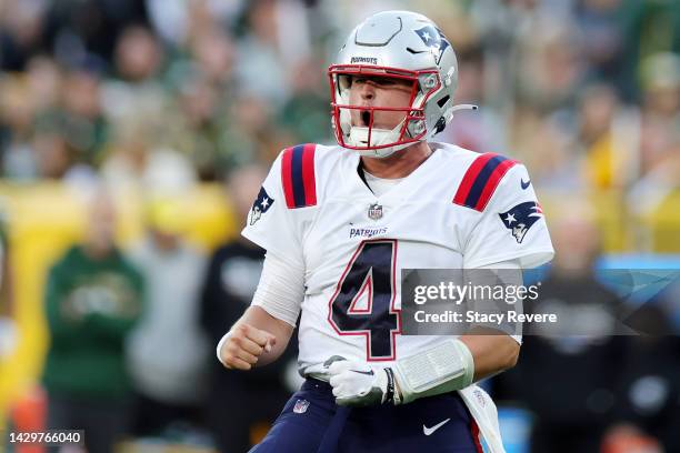 Bailey Zappe of the New England Patriots celebrates a touchdown by Damien Harris of the New England Patriotsduring the fourth quarter against the...