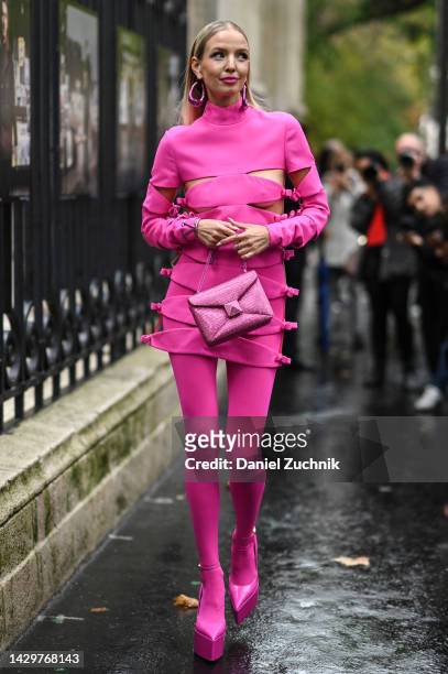 Leonie Hanne is seen wearing a pink Valentino dress, pink stockings, Valentino bag, Valentino shoes and pink earrings outside the Valentino show...