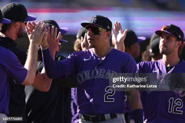 Yonathan Daza of the Colorado Rockies high-fives teammates after a 4-1 win over the Los Angeles Dodgers at Dodger Stadium on October 02, 2022 in Los...