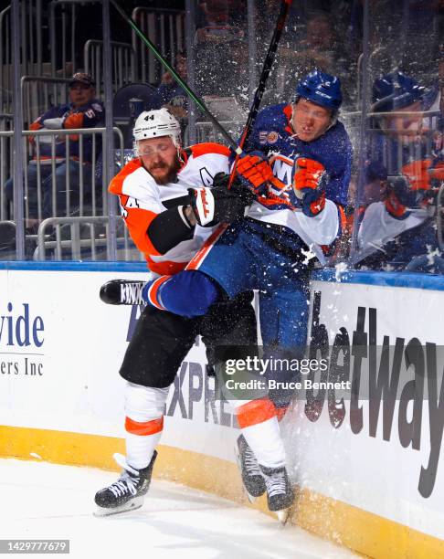 Nicolas Deslauriers of the Philadelphia Flyers checks Robin Salo of the New York Islanders into the glass during the first period at the UBS Arena on...