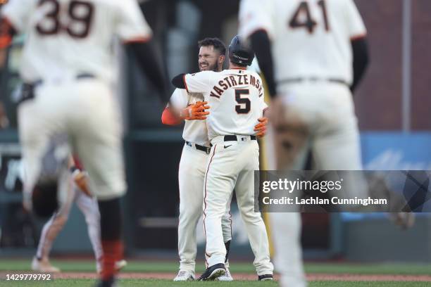 David Villar of the San Francisco Giants celebrates with Mike Yastrzemski after hitting a two-run single in the bottom of the tenth inning to defeat...