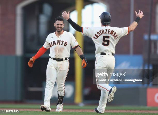 David Villar of the San Francisco Giants celebrates with Mike Yastrzemski after hitting a two-run single in the bottom of the tenth inning to defeat...