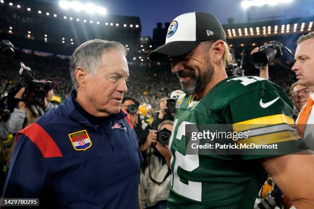 Head coach Bill Belichick of the New England Patriots and Aaron Rodgers of the Green Bay Packers talk after Green Bay's 27-24 win in overtime at...
