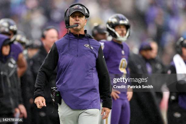 Head coach John Harbaugh and kicker Justin Tucker of the Baltimore Ravens look on from the sideline before a fourth down conversion attempt against...