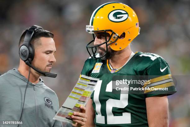 Head coach Matt LaFleur of the Green Bay Packers talks to Aaron Rodgers of the Green Bay Packers during overtime against the New England Patriots at...