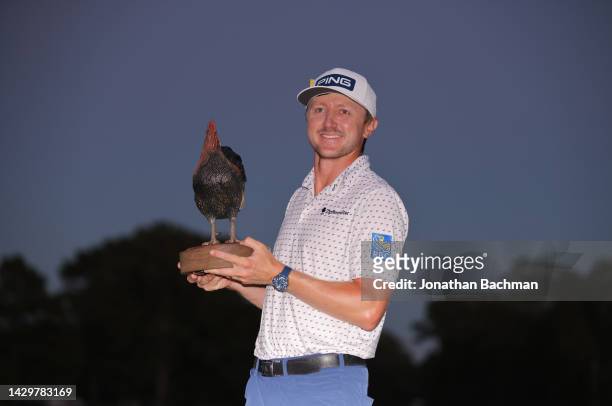 Mackenzie Hughes of Canada poses with the trophy after putting in to win on the second playoff hole against Sepp Straka of Austria on the 18th green...