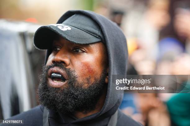 Kanye West aka Ye is seen wearing a Balenciaga boxing mouthguard, outside Givenchy, during Paris Fashion Week - Womenswear Spring/Summer 2023 - Day...