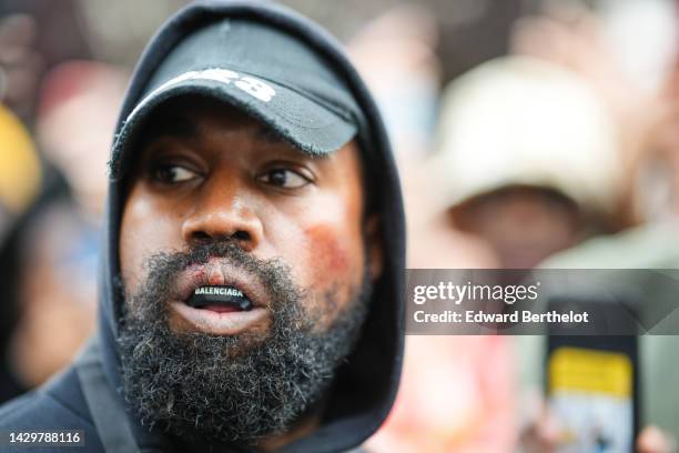 Kanye West aka Ye is seen wearing a Balenciaga boxing mouthguard, outside Givenchy, during Paris Fashion Week - Womenswear Spring/Summer 2023 - Day...