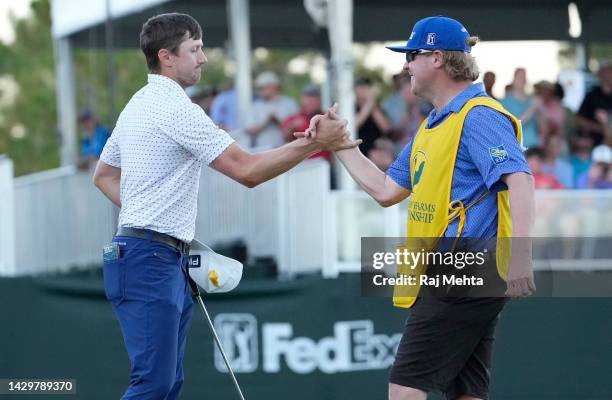 Mackenzie Hughes of Canada celebrates with his caddie Jace Walker on the second playoff hole against Sepp Straka of Austria on the 18th green during...