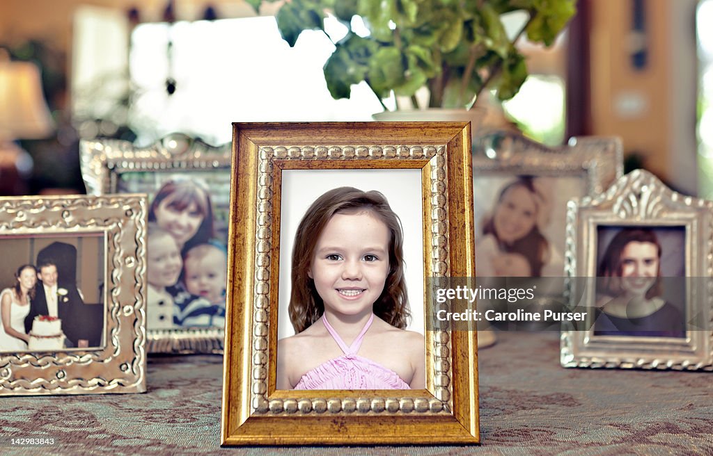 Young girl's picture in a frame with others behind