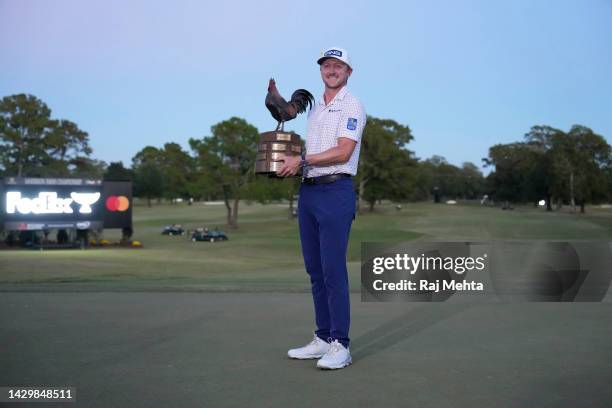 Mackenzie Hughes of Canada poses with the trophy after putting in to win on the second playoff hole against Sepp Straka of Austria on the 18th green...