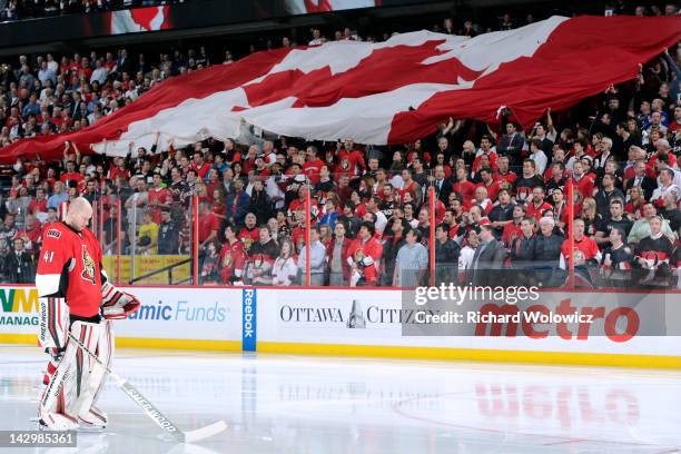 Craig Anderson of the Ottawa Senators stands during the singing of the Canadian national anthem prior to facing the New York Rangers in Game Three of...